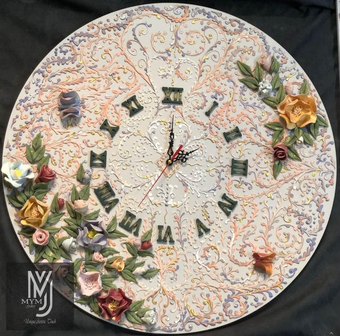 Round wall clock with raised pastel scrollwork, Roman numerals and sculpted flowers along its edge