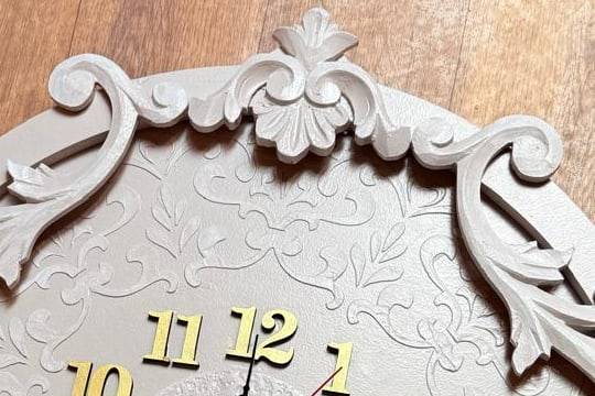 Carved scroll ornament at the top of the clock