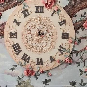 The clock dial among the branches